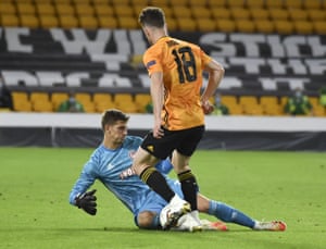 Olympiakos’ goalkeeper Bobby Allain, left, stops a shot from Wolverhampton Wanderers’ Diogo Jota.