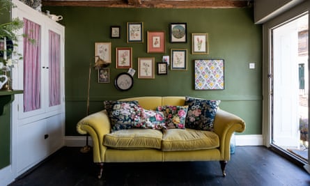 Chartreuse velvet sofa with floral cushions and vintage prints and original artworks.
