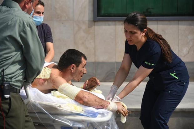 Armenian medics help a man, who said was injured in clashes in Azerbaijan’s breakaway region of Nagorno Karabakh.
