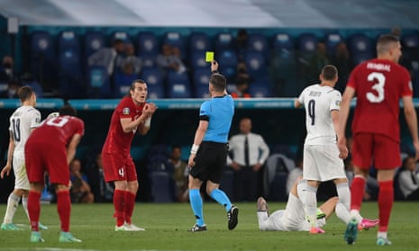 Turkey’s defender Caglar Soyuncu is shown a yellow card.