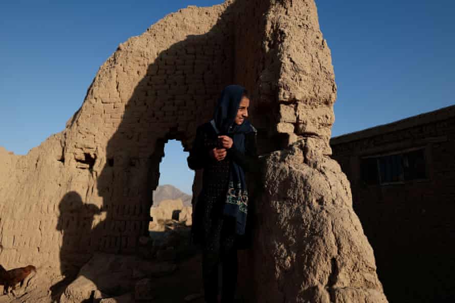 Agency photographer of the year – 2021 shortlist | World news 9 Bassira, 11, looks on after she finished feeding her chickens on the outskirts of Kabul, Afghanistan 1 November 2021.
