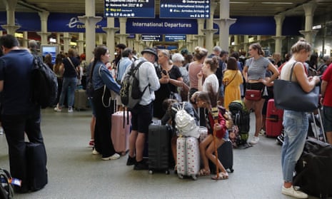 People wait to board the Eurostar at St Pancras International train station in London