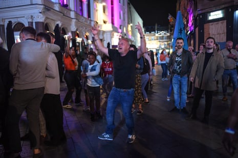 People are seen dancing to a busker in Leicester Square on 12 September, 2020 in London, England. From Monday, 14 September, groups of more than six will be banned from meeting under new coronavirus restrictions.