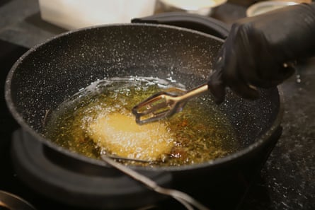 Deep-frying a burger.