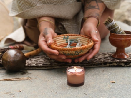 A women holding a straw basket on top of a blanket