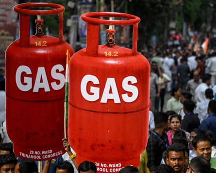 Trinamool Congress party supporters carry cutouts of LPG cylinders at a rally in Kolkata