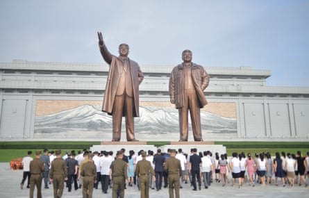 People pay their respects before the statues of late North Korean leaders Kim Il-sung and Kim Jong-il at Mansu Hill as North Korea marks its 78th National Liberation Day, on 15 August, 2023.