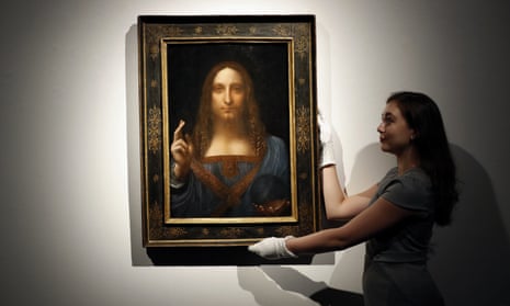 An employee poses with Leonardo da Vinci’s “Salvator Mundi” on display at Christie’s auction rooms in London in 2017.