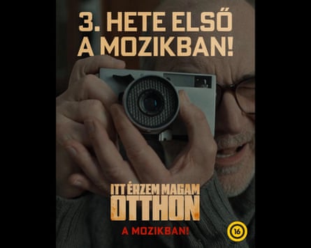 A poster for Feels Like Home showing a man taking a photograph.