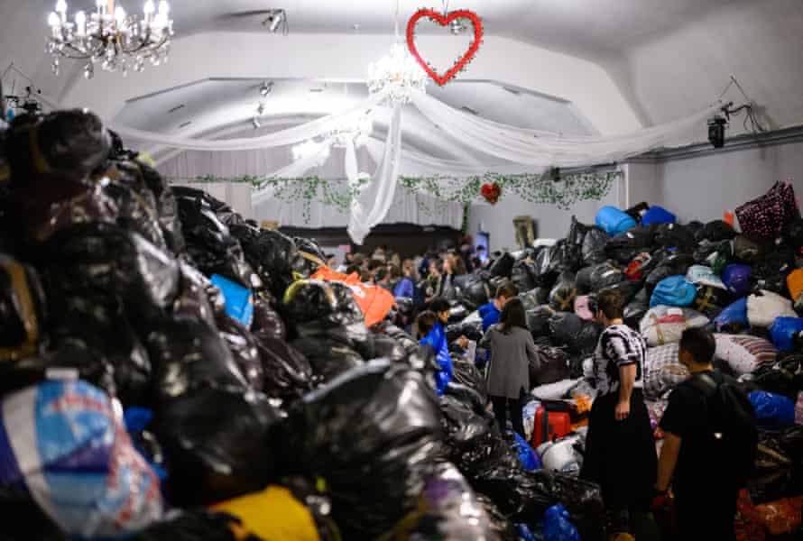 Volunteers work together to sort through donations delivered to the White Eagle Club in London.