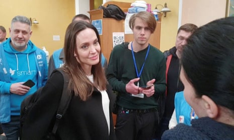 Angelina Jolie listening to volunteers during a visit to Lviv's main railway station.