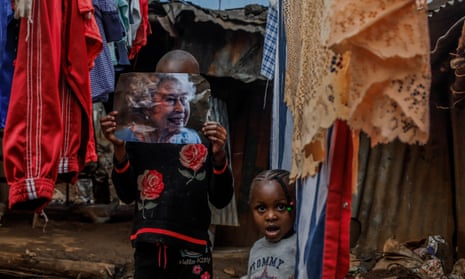 A girl holds a newspaper image of Queen Elizabeth II on 9 September 2022 in Nairobi, Kenya. 