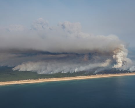 The wildfire north of the Arcachon basin covering the forest, with a view of a beach and the Atlantic Ocean near Lege-Cap-Ferret, southwestern France.