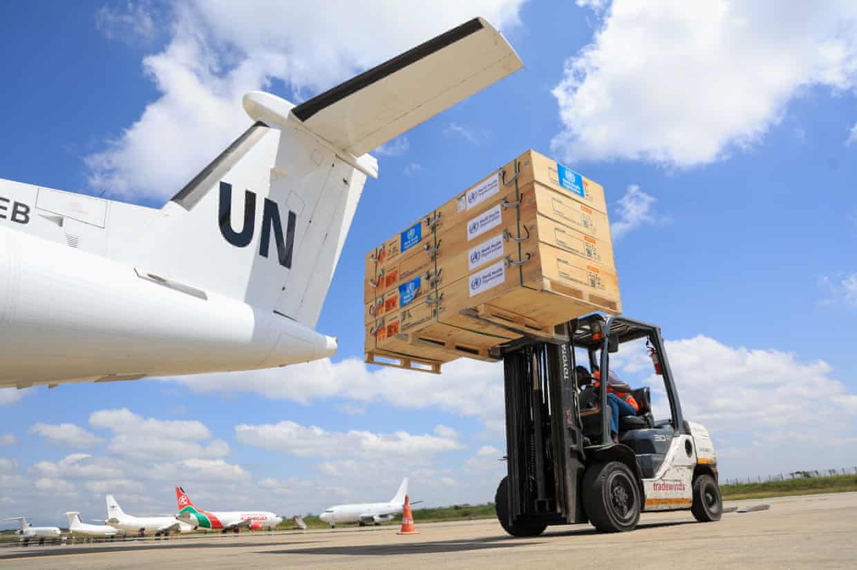 Workers load World Health Organization emergency supplies on to a UN plane in Nairobi, Kenya