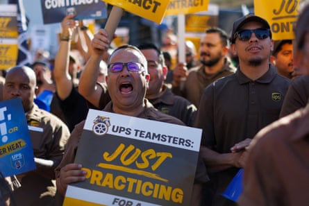 Teamsters employed by UPS hold a rally outside a UPS facility in Los Angeles on 19 July.
