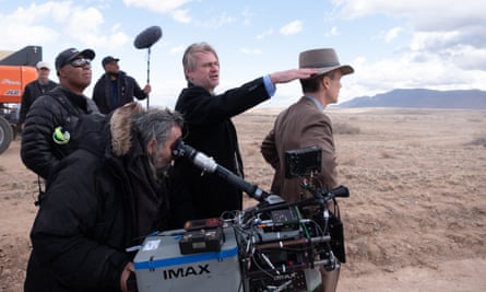 Director Christopher Nolan, center, and Cillian Murphy, right, on the set of “Oppenheimer.”