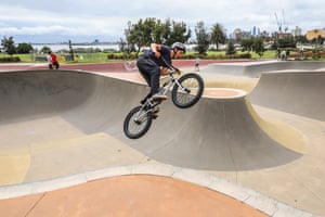 A young man rides his bike at a skatepark in Melbourne, Australia