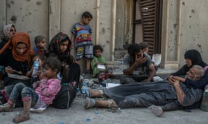 Iraqis sheltering in an Isis-controlled part of Mosul’s old city on 11 July. Government forces have declared victory but fighting continues in several pockets.