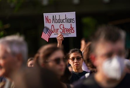 a women holding a sign saying ‘No Abductions, Our Streets’