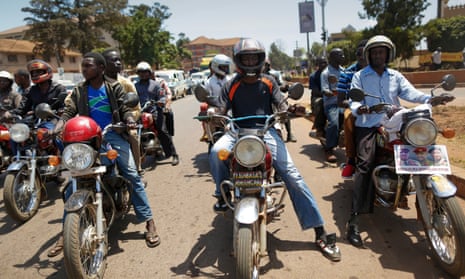Boda boda drivers and motorcyclists at a traffic signal in Kampala
