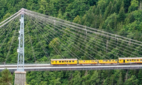 The tourist train connecting Villefranche-de-Conflent to Latour-de-Carol, passing over the Bridge of Cassagne, in the Pyrenees.