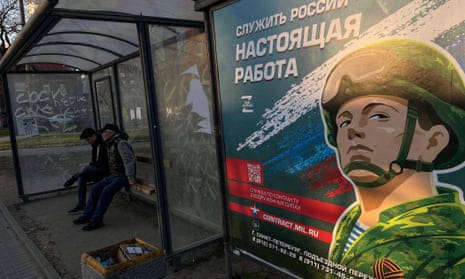 ‘Serving Russia is the real job’ reads a poster promoting army service in a bus stop in Saint Petersburg.