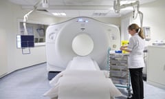 A radiographer preparing a MRI scanning machine.