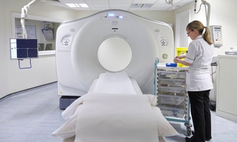 A radiographer preparing a MRI scanning machine for a patient