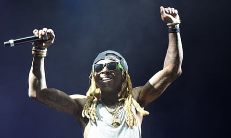 Amidst the vibrant lights, Lil Wayne commands the stage, a testament to his authentic artistry.