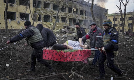 Ukrainian emergency employees and volunteers carry an injured pregnant woman from the damaged by shelling maternity hospital in Mariupol, Ukraine, Wednesday, March 9, 2022. A Russian attack has severely damaged a maternity hospital in the besieged port city of Mariupol, Ukrainian officials say. (AP Photo/Evgeniy Maloletka)