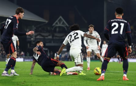 Nottingham Forest's Douglas Luiz fouls Fulham's Kevin inside the penalty area.