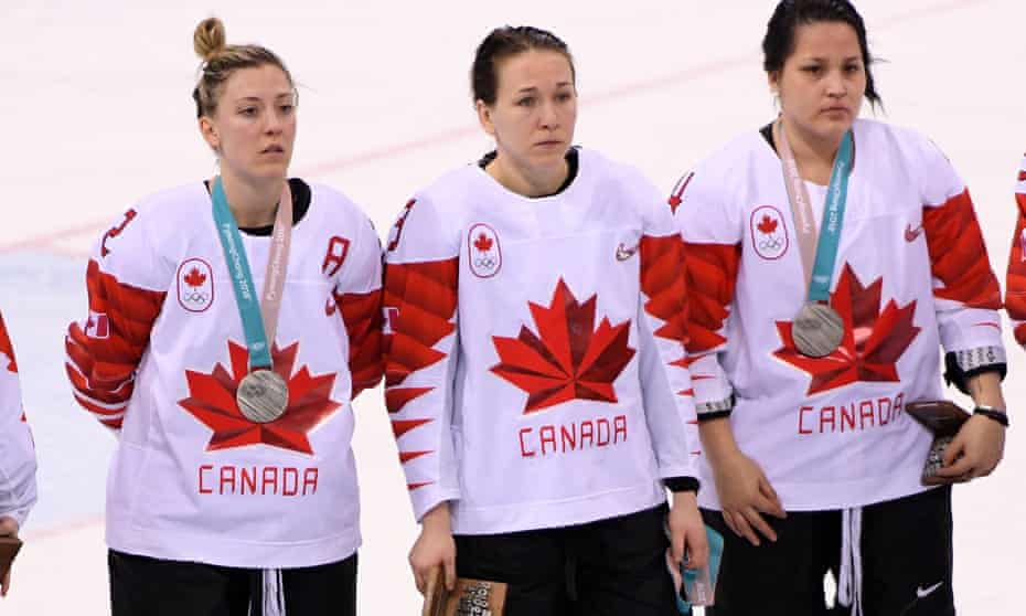 Larocque (centre) removed her medal and held it in her hand during the ceremony on Thursday