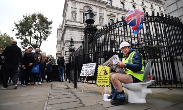Bray sits on a toilet outside 10 Downing Street in October 2021, after Conservatives voted against a bill that would have cracked down on water companies pumping out raw sewage.