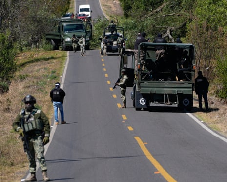 soldiers stand along a road
