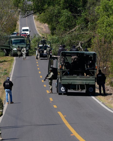 soldiers stand along a road