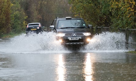 A motorist drives along a flooded road in Mountsorrel, Leicestershire
