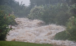 Heavy rainfall from Hurricane Lane causes a small stream to overflow on to Akolea Road in upper Kaumana, near Hilo, Hawaii.