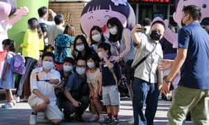 Parents and kids pose at school’s garden on the first day of school amid coronavirus measures in Taipei, Taiwan.