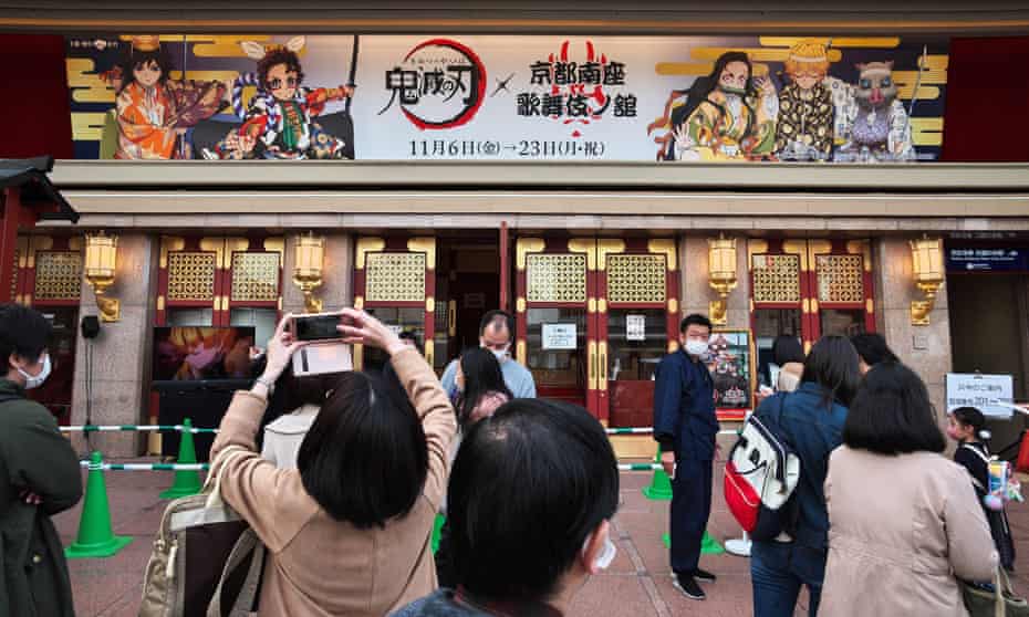 People take photos outside an exhibition about Demon Slayer in Kyoto, Japan