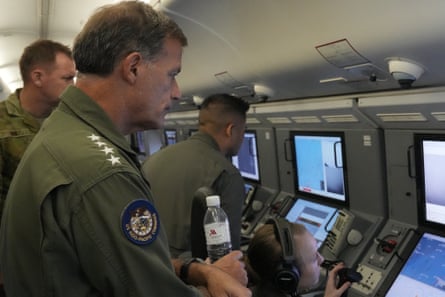 Admiral John C Aquilino (left) commander of the US Indo-Pacific Command, looks at videos of Chinese structures and buildings on board a US P-8A Poseidon reconnaissance plane flying at the Spratlys group of islands in the South China Sea on Sunday.