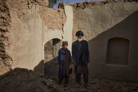 Sayed Mohammad* and his son Adbul Wadood* stand in their damaged home in Marja in Helmand Province.