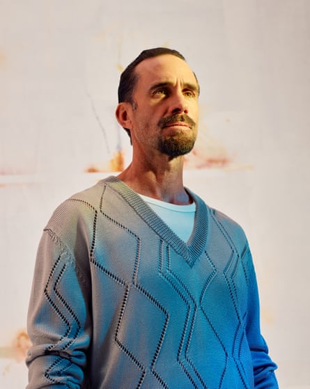 Actor Joseph Fiennes in white T-shirt and blue V-neck jumper