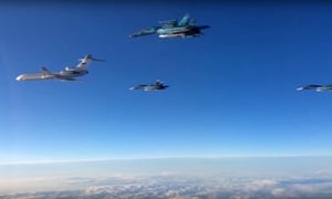 A screengrab from footage of planes flying from Hmeymim airbase to Russia.