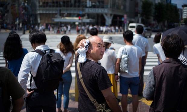A man wipes perspiration from his head in Tokyo