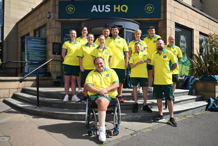 Members of the men’s and women’s Australian bowls and para bowls team pose for a photo outside their team headquarters in Glasgow