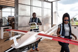 Eliane Nirere and Prosper Uruvugundi prepare a drone for take-off from Muhanga.