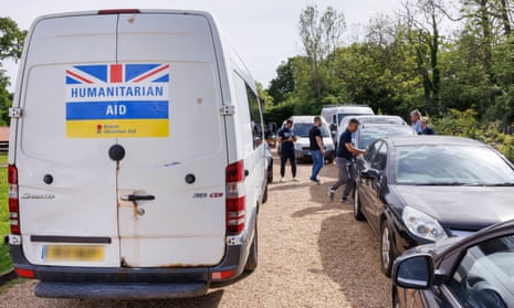 Parked vehicles with British and Ukrainian flags on them