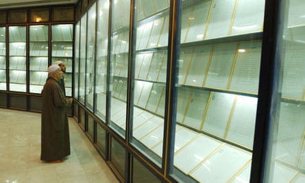 Two Imams view the 605-page Quran written with 24 litres of Iraqi leader Saddam Hussein’s own blood, on display in Umm al-Maarik mosque in Baghdad in 2003.