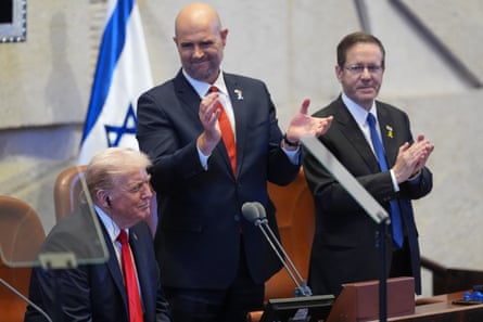 Amir Ohana (centre) applauding Donald Trump alongside Isaac Herzog (right) before the US president spoke in the Knesset in October 2025.