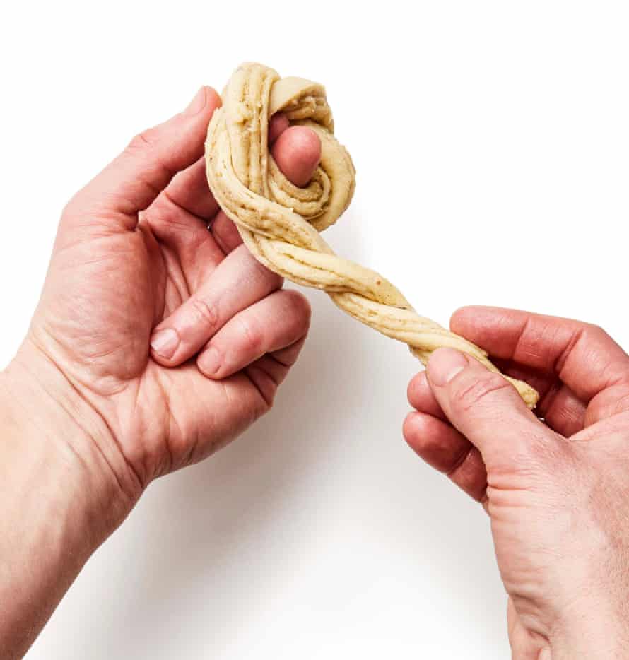 Felicity Cloake’s perfect cardamom buns – step 7c. Wind each plait into a coil around your finger, tucking the end through the middle to secure.